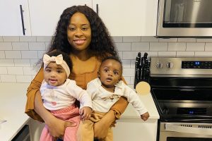 Charis, founder of Yum and Yummer, with her snack-sized sous chefs in a modern kitchen